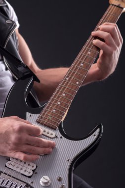 Professional male guitarist is playing with aspiration