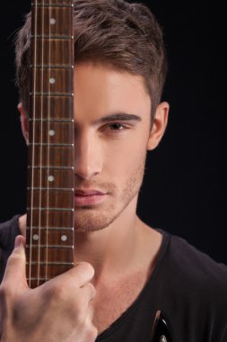 Cheerful young guitarist with a musical instrument