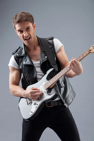 Attractive male musician is making real music — Stockfoto