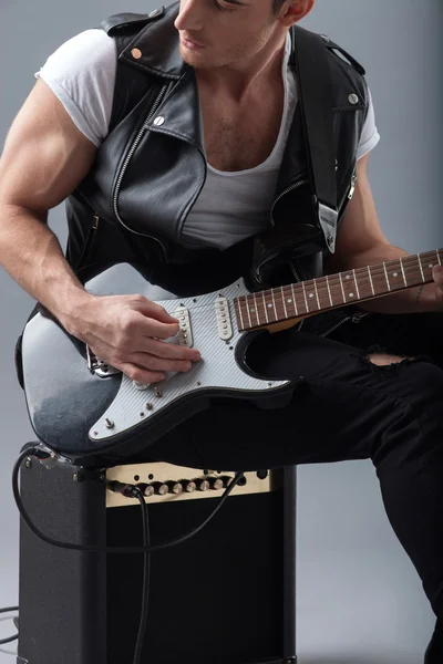 Handsome male musician is playing musical instrument — Φωτογραφία Αρχείου