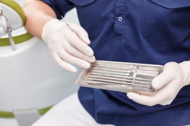 Experienced young dentist is working with new equipment