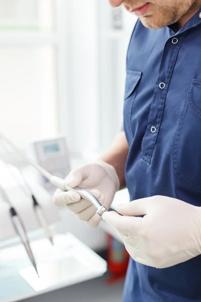 Skilled young dental doctor is working in his cabinet — 图库照片