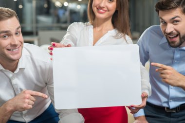 Skillful young business partners are presenting billboard
