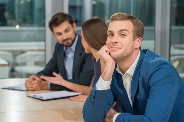 Cheerful young colleagues are discussing new project — Stock Photo, Image