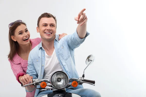 Cheerful young loving couple is driving motorbike — 图库照片