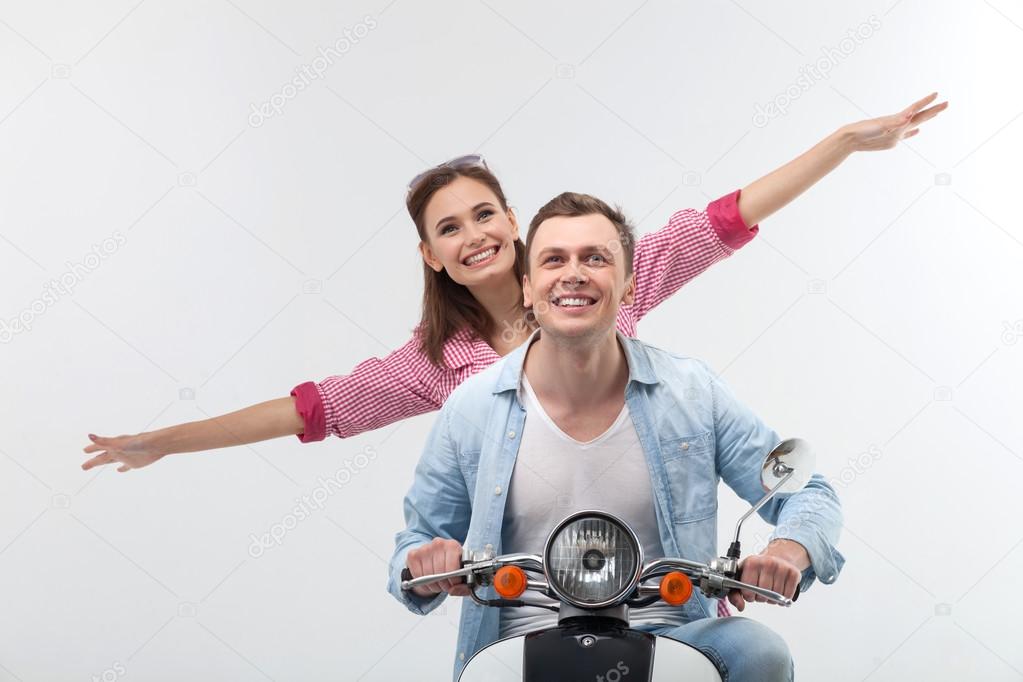 Attractive boyfriend and girlfriend on motor bike