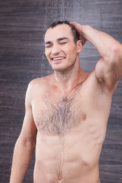 Handsome young guy is cleaning his hair — Stok fotoğraf