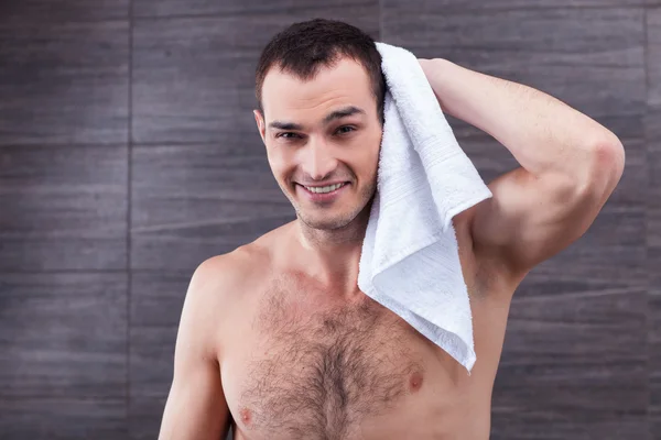 Handsome fit guy is drying himself after bathing — 图库照片