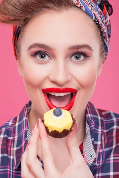 Cute young woman is eating sweet food — Zdjęcie stockowe