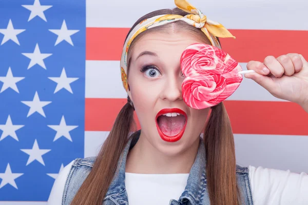 Attractive American girl with sweet colored candy — Stock Photo, Image