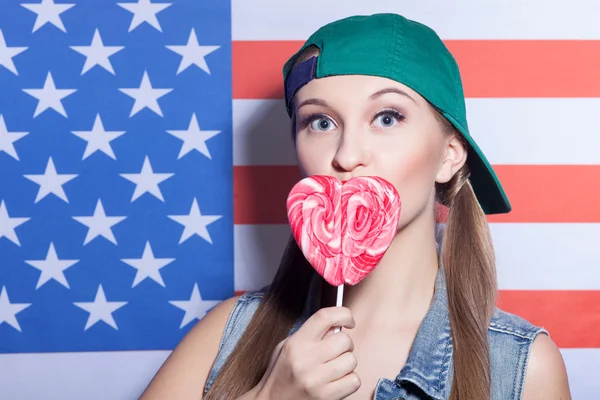 Pretty young American girl with sweet lollipop — Zdjęcie stockowe