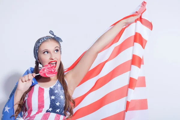 Beautiful American girl with sweet colored candy — Zdjęcie stockowe