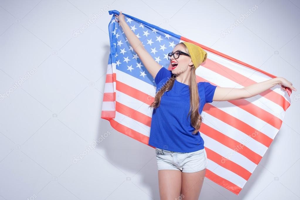 Cheerful young woman is expressing her patriotism