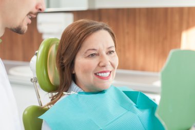 Cute old lady is visiting dental doctor