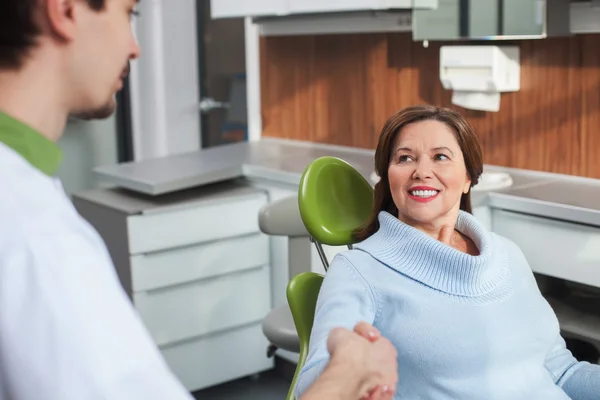 Cute mature lady is visiting the orthodontist