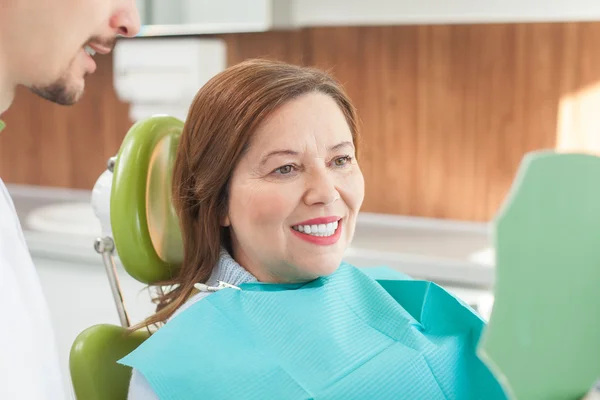 Cute old lady is visiting dental doctor
