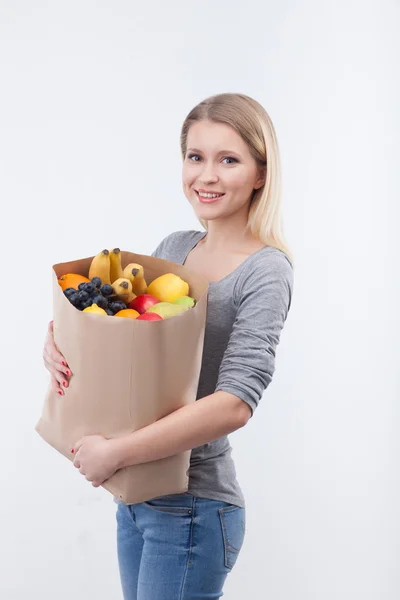 Cheerful young woman with natural organic products — Stok fotoğraf