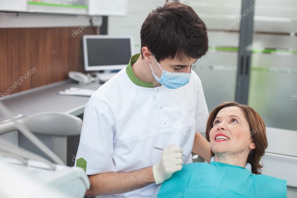 Professional male dental doctor is making treatment — Stock Photo