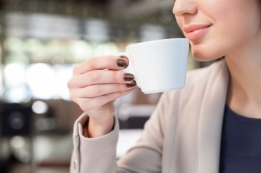 Cheerful young lady is relaxing in cafe