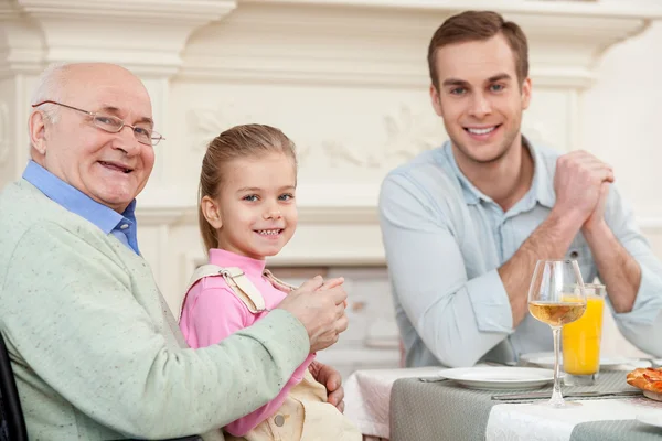 Cute friendly family is dining together — Zdjęcie stockowe