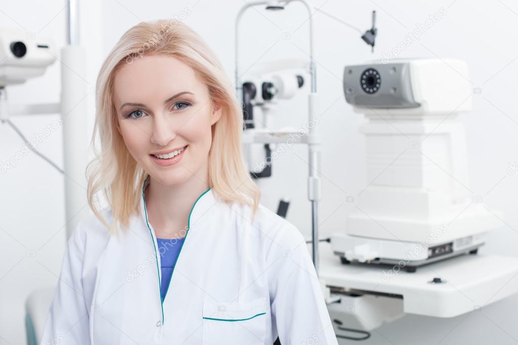Attractive female ophthalmologist is working in clinic