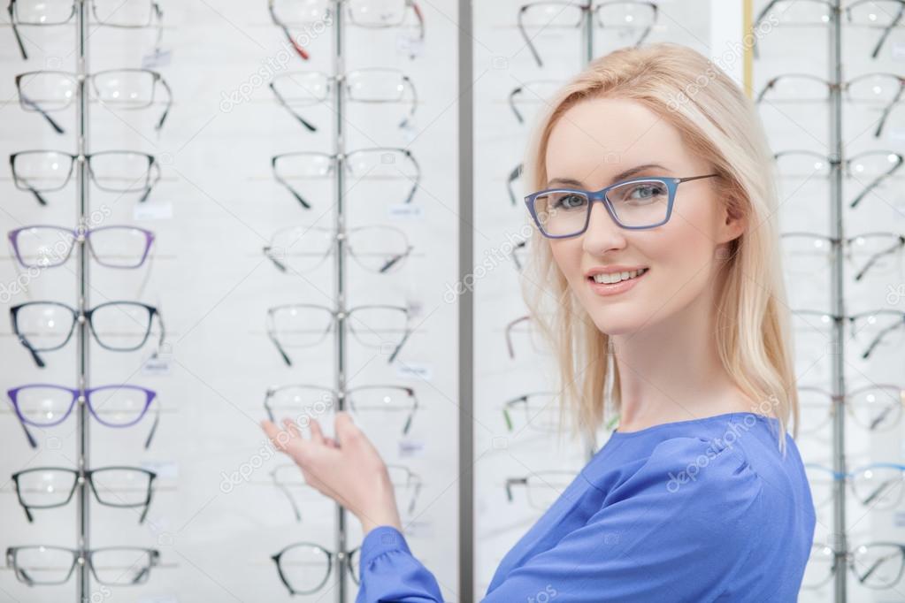 Beautiful blond girl wants to buy eyeglasses