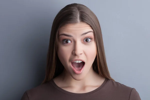 Cheerful young woman is expressing her surprise — Stok fotoğraf