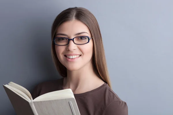 Attractive young woman is learning literature with joy — Stock Fotó