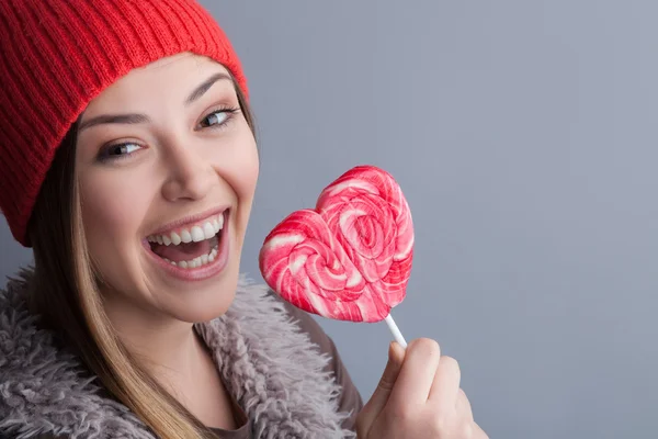 Attractive healthy woman is enjoying tasty candy — Zdjęcie stockowe