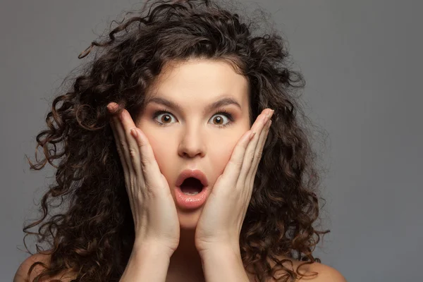 Cheerful young woman is expressing her surprise — Stock fotografie