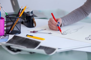 Cheerful female photographer is working with blueprint