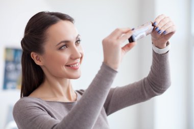 Cute young photographer is viewing old shots