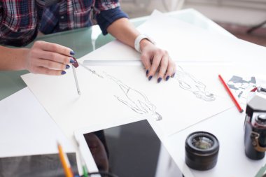 Skillful young photo artist is working with sketches