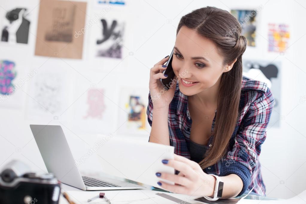 Pretty Female Photo Artist Is Communicating On Telephone - 