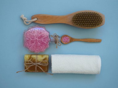 Evde vücut bakımı için mavi arka planda spa öğeleri kümesi, düz yatış, üst görünüm