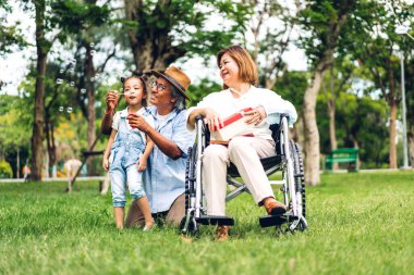 Mutlu Asyalı büyükbaba ve büyükannesinin portresi ve Asyalı küçük tatlı kız yaz parkında rahatlayın. Gülen büyükannesi ve büyükbabası birlikte gülümseyen genç kız. Aile ve beraberlik.