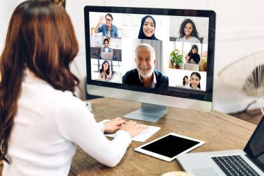 Kadın konuşması, dizüstü bilgisayarın çalışması ve evdeki iş arkadaşlarıyla çevrimiçi video konferansı kullanarak konuşuyor. Yaratıcı kadın, ev konseptinden iş ekibiyle görüntülü konuşma görüşmesi yapıyor.