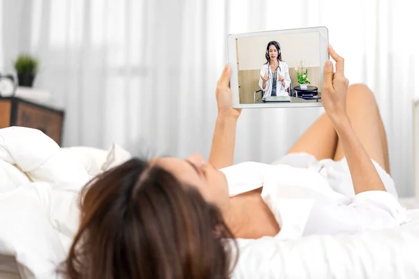 Woman talk speak using tablet computer and video conference online with doctor and stethoscope service help support discussing and consulting talk video chat call about checkup result information