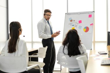 Mutlu çağrı merkezi gülümseme operatörü müşteri destek ekibi telefon hizmeti ajansı çağrı merkezindeki masaüstü bilgisayarında çalışıyor ve kulaklıkla konuşuyor