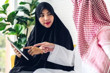 Tablet bilgisayarla çalışan iki Arap iş adamının başarısı. Modern ofiste planlama ve beyin fırtınası yapan yaratıcı Arap insanlar. Takım çalışması kavramı.