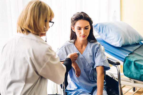 Senior woman doctor wearing uniform with stethoscope service help support discussing and consulting talk to sick woman patient about checkup result information in hospital