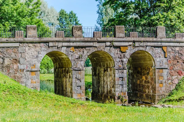 Old dilapidated stone bridge — Stok fotoğraf