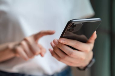 Sosyal ağda elinde tutan ve akıllı telefon kullanan kadın SMS mesajı yazıyor.