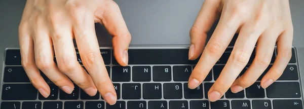 close up of hand using on keyboard laptop and typing with social media on internet.