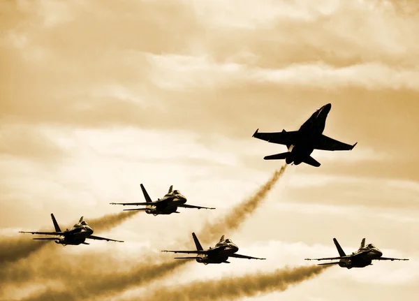 Silhouetted Jets flying at sunset