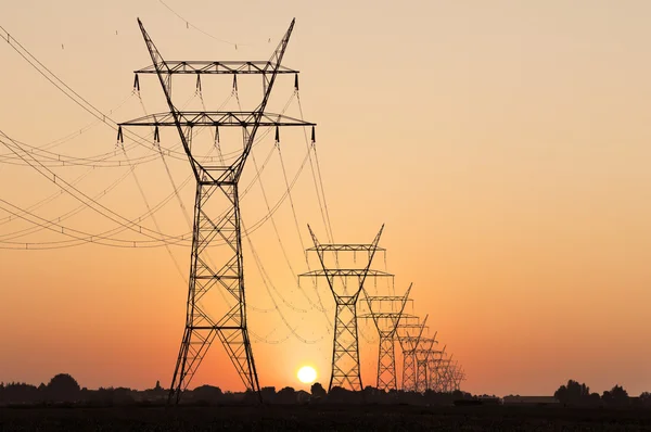 High voltage pylon in sunset — Stock Photo, Image