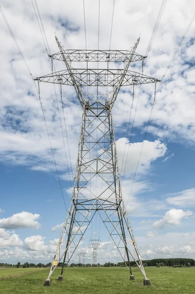 Large high voltage pylons in green landscape — Stock Photo, Image