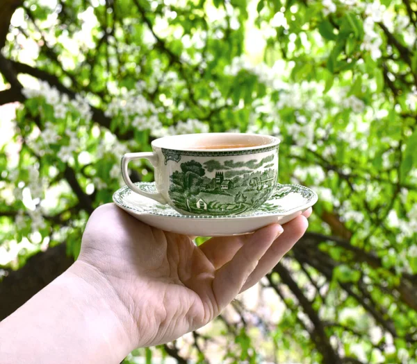A cup of tea in a hand