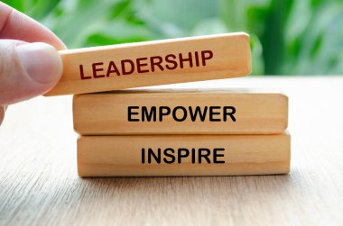 Leadership, empower and inspire text on wooden blocks. Leadership concept