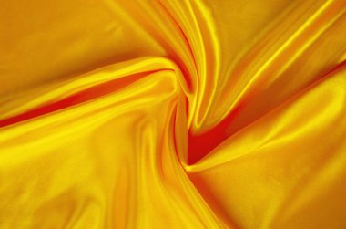 Çarpıcı kıvrımlı kıvrımlı altın ipek kumaş dokusu ve soyut lüks arka planlar için ışıltılı röfleler